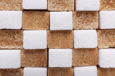 Photo of White and brown sugar cubes as background, top view