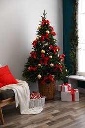 Stylish room interior with decorated Christmas tree