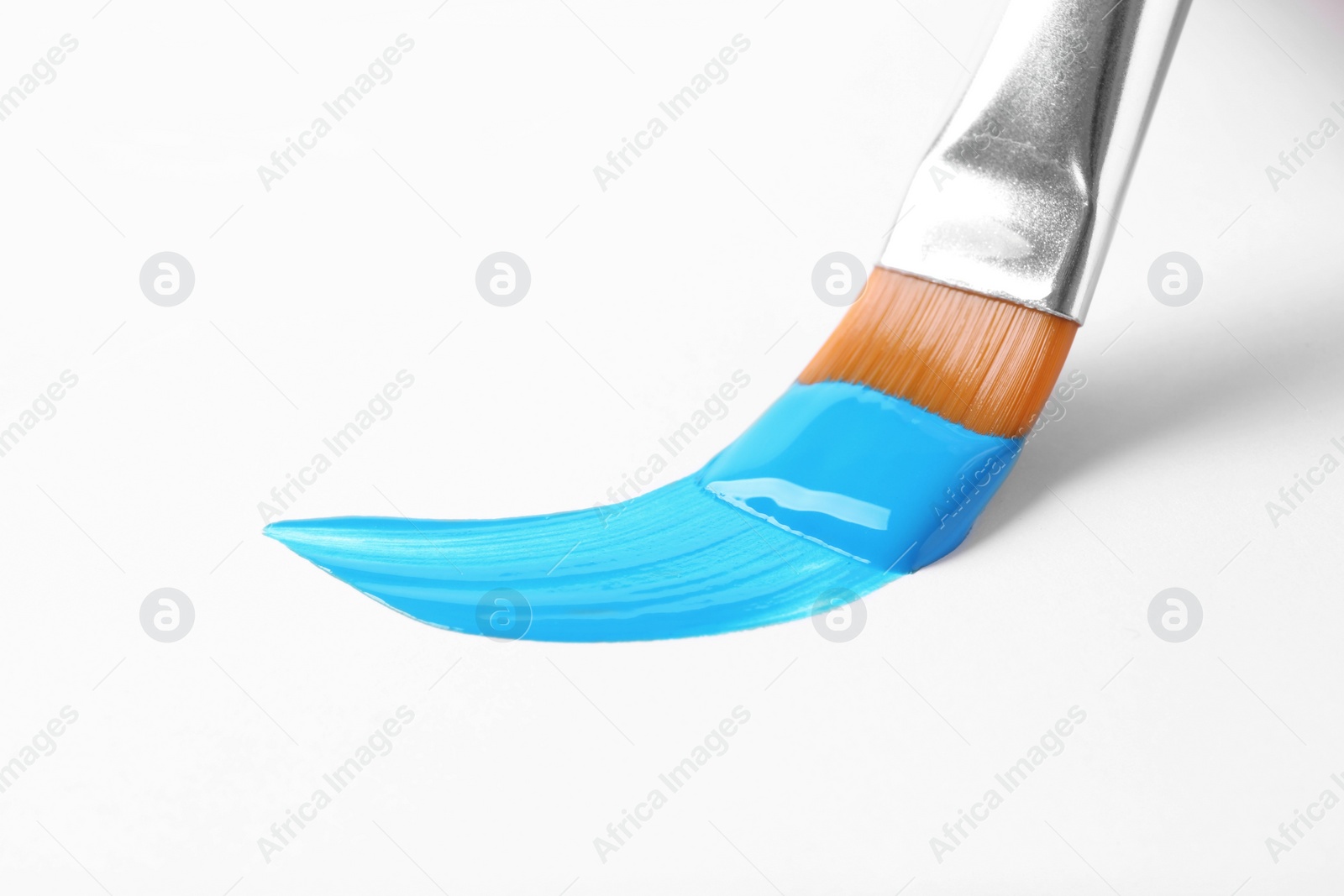 Photo of Brush with color paint and stroke on white background