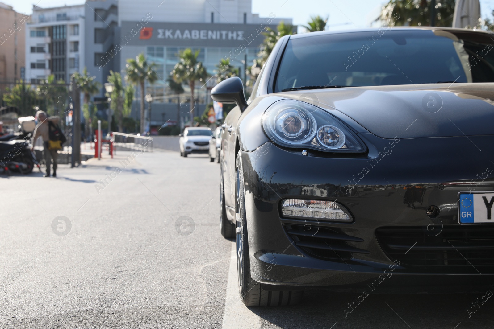 Photo of PIRAEUS, GREECE - MAY 19, 2022: Black Porsche Panamera car on city road