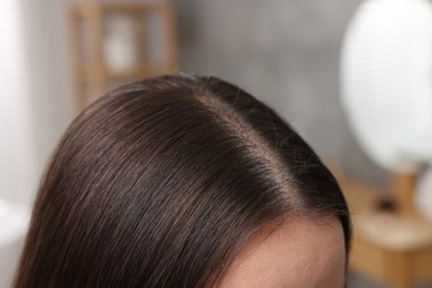 Photo of Woman with healthy hair indoors, closeup view