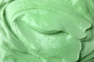 Photo of Texture of light green professional face mask as background, closeup