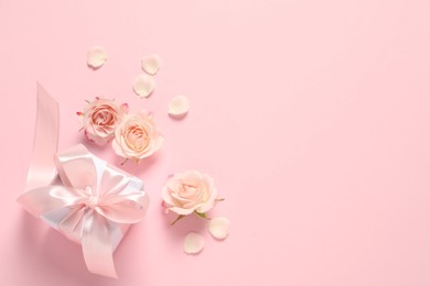 Photo of Happy Mother's Day. Beautiful flowers and gift box on pink background, flat lay. Space for text