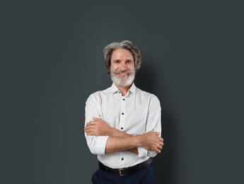 Photo of Portrait of handsome mature man on dark background