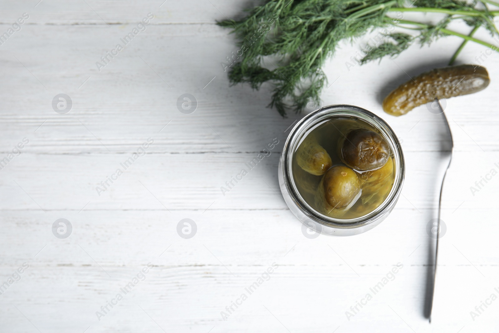 Photo of Flat lay composition with pickled cucumbers on white wooden table, space for text