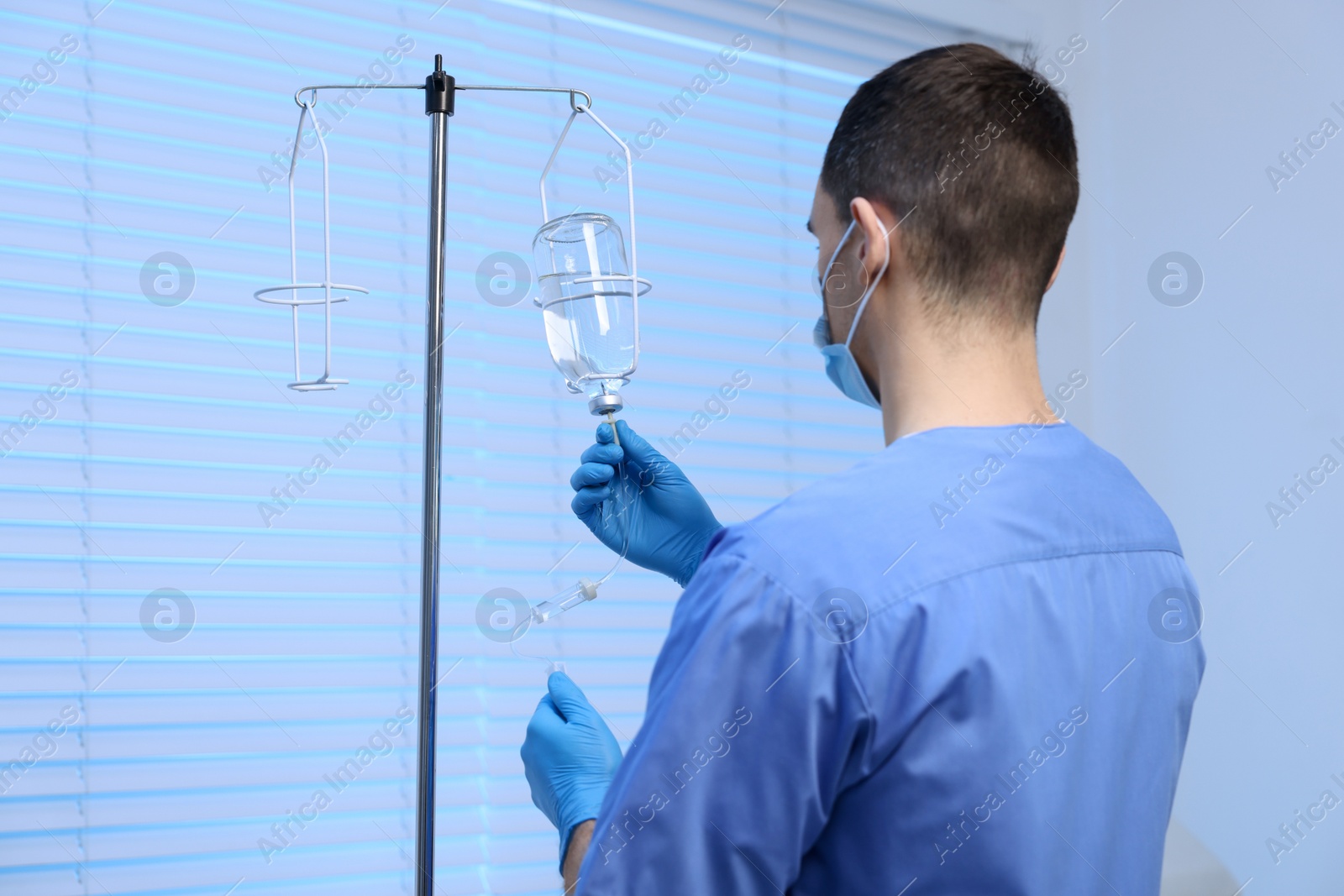 Photo of Nurse setting up IV drip in hospital