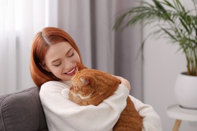 Happy woman with her cute cat at home