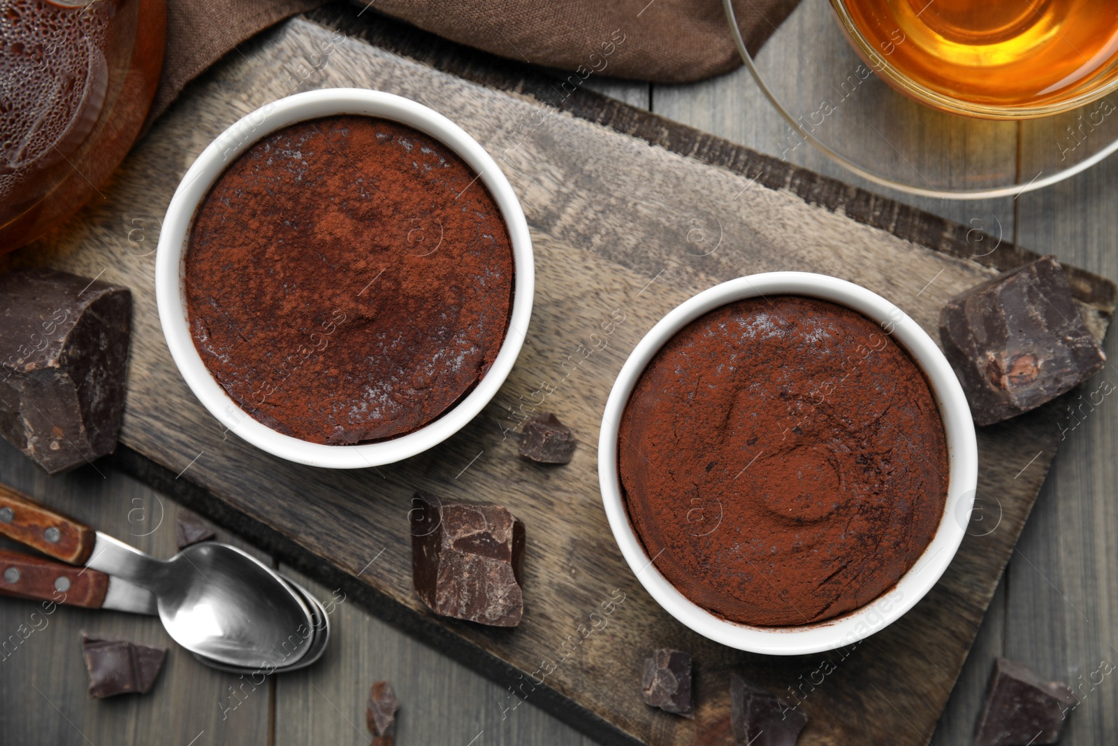 Photo of Delicious fresh fondant and chocolate chunks on wooden table, flat lay