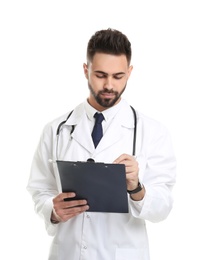 Photo of Young male doctor in uniform with clipboard isolated on white