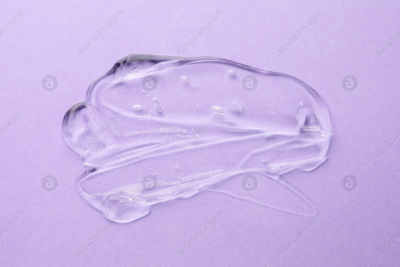 Photo of Clear cosmetic gel on violet background, top view