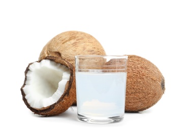 Photo of Glass of coconut milk and nuts on white background