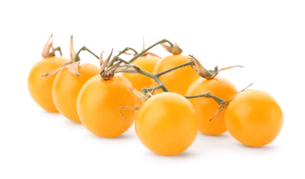 Photo of Branch of ripe yellow cherry tomatoes on white background