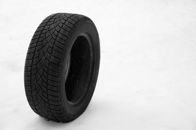 New winter tire on fresh snow. Space for text