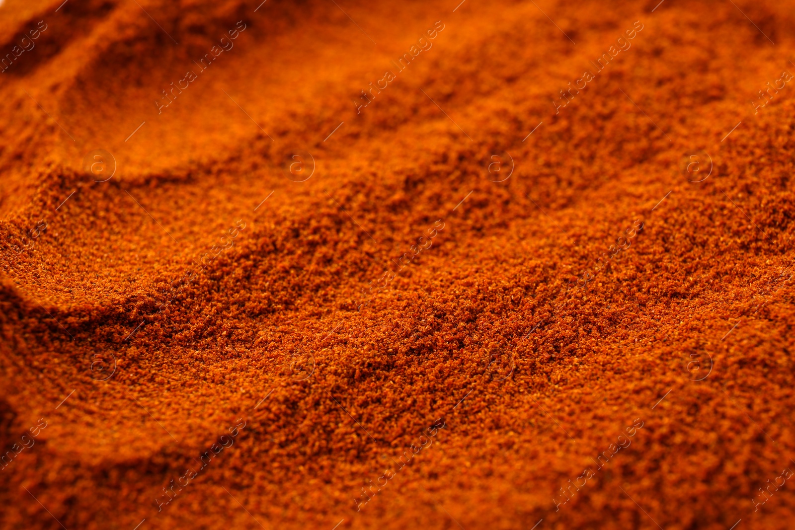 Photo of Aromatic paprika powder as background, closeup view