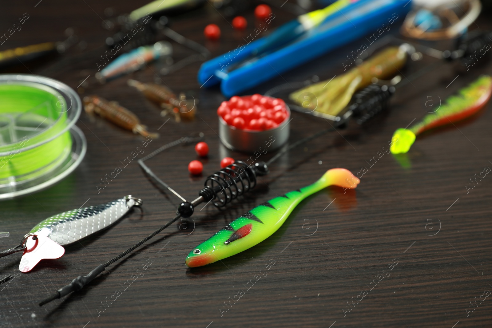 Photo of Fishing tackle on dark wooden background, closeup