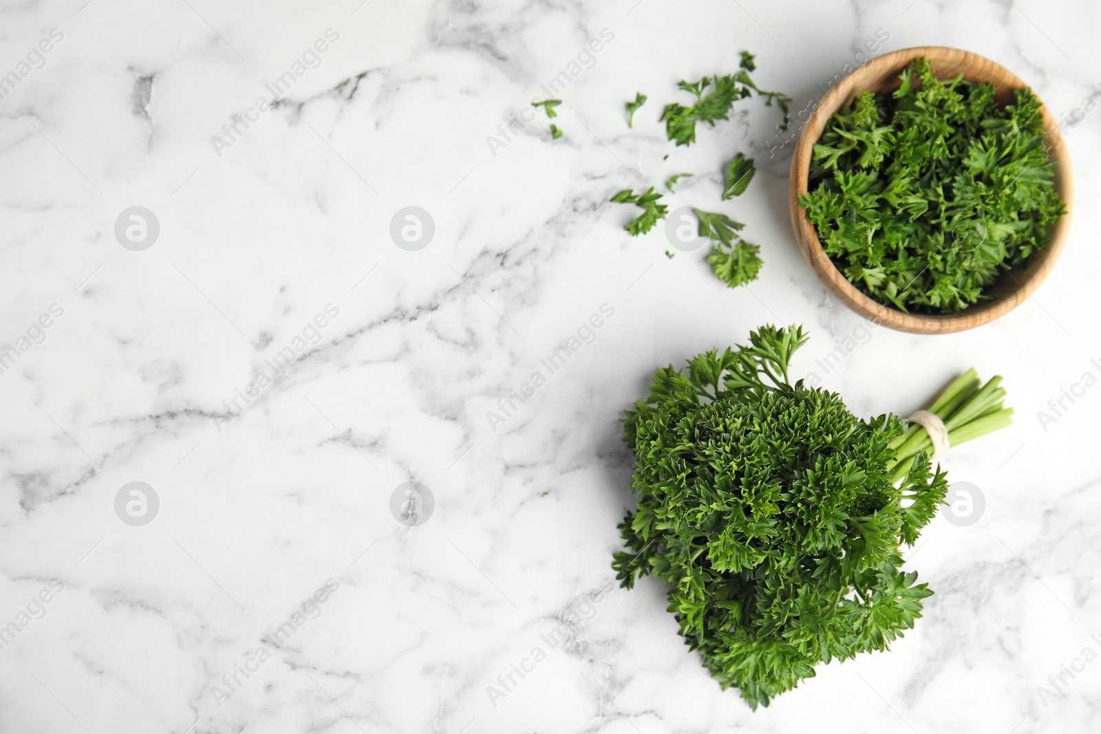 Photo of Flat lay composition with fresh green parsley on marble table, space for text