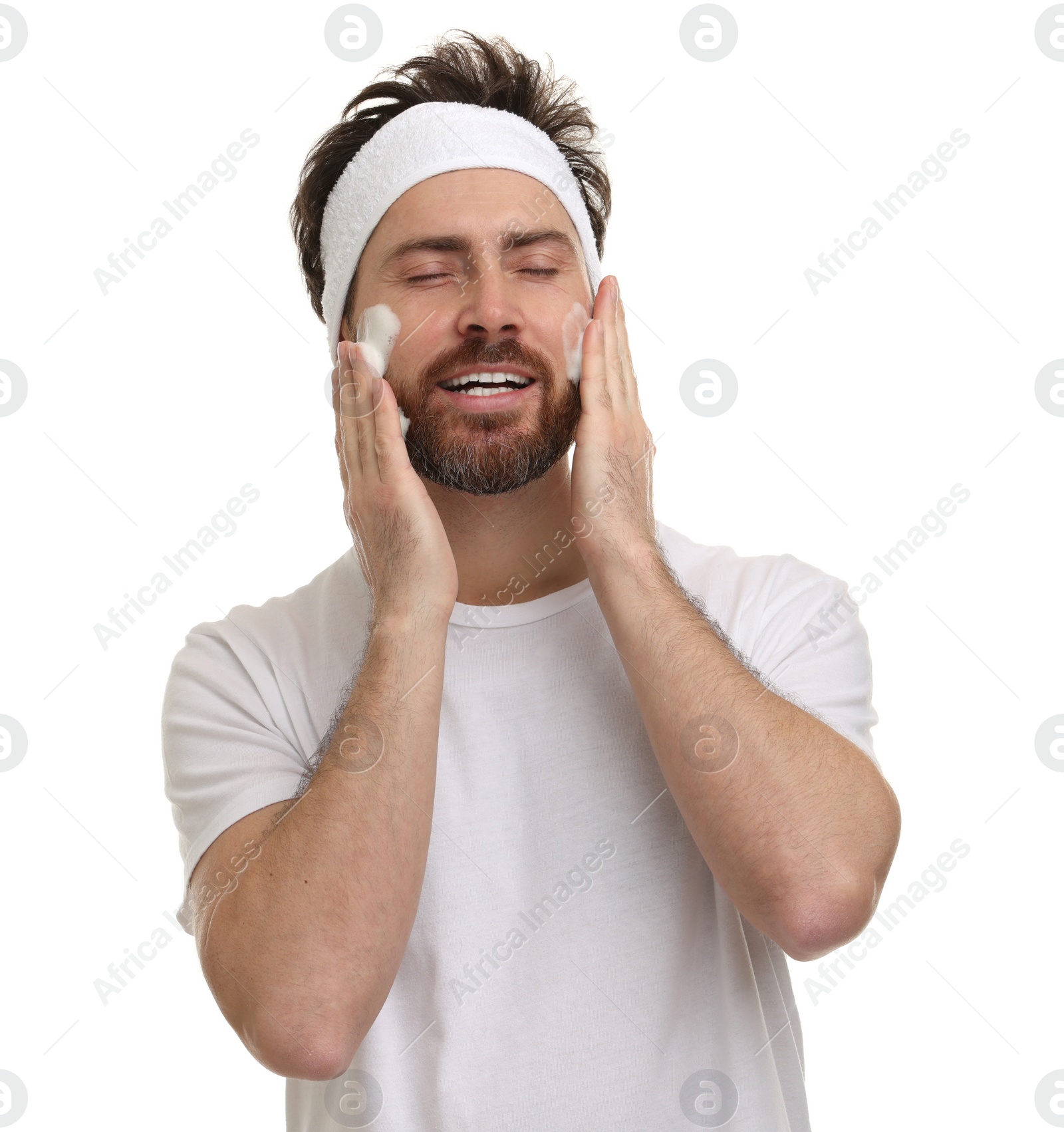 Photo of Man with headband washing his face on white background