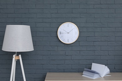 Stylish room interior with wall clock. Time of day