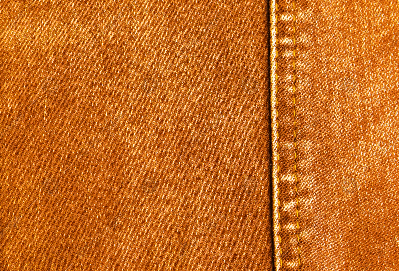 Image of Texture of orange jeans as background, closeup