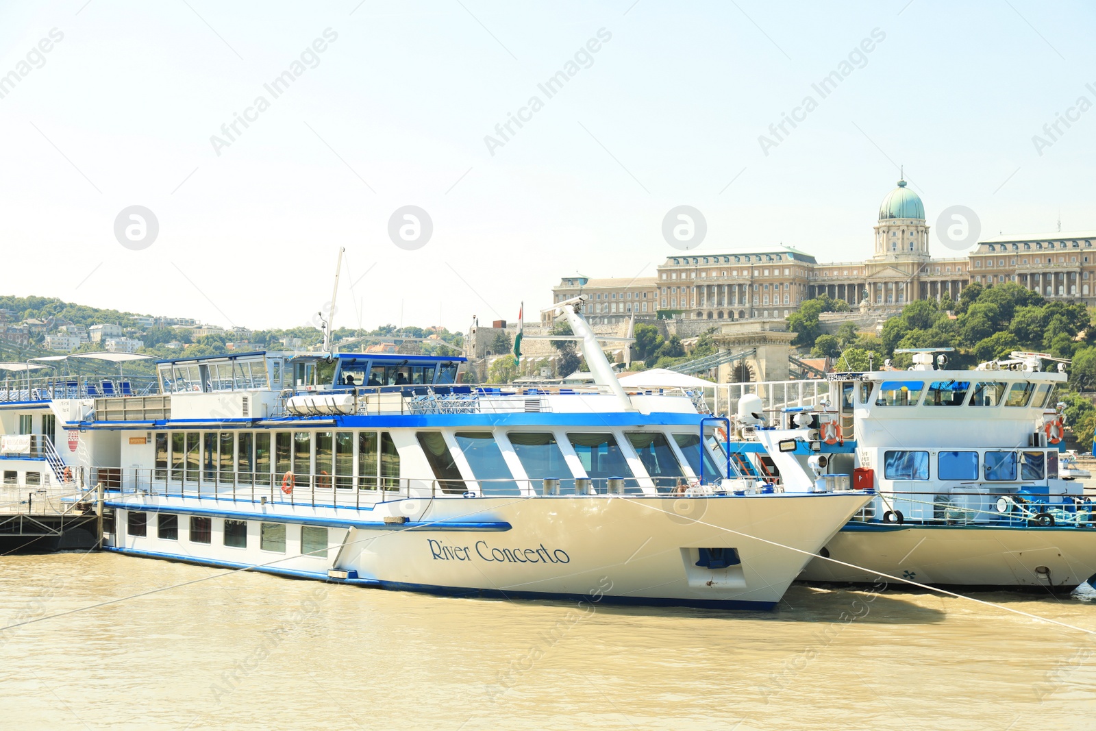 Photo of BUDAPEST, HUNGARY - JUNE 18, 2019: Beautiful view with Buda Castle, Szechenyi Chain Bridge and tour boats on Danube river