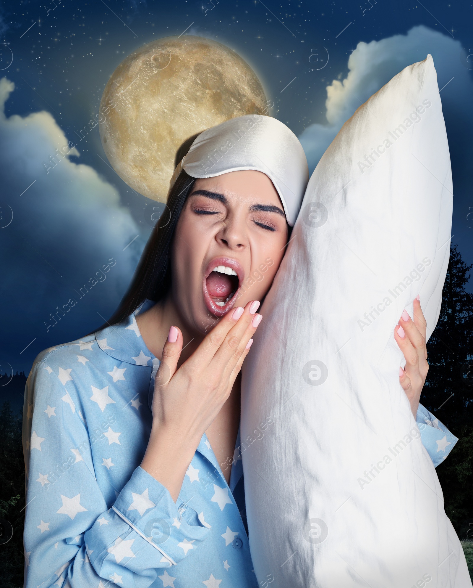 Image of Young tired woman with pillow and beautiful view of full moon in night sky