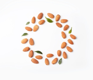 Photo of Frame made of organic almond nuts on white background. Space for text