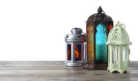 Photo of Decorative Arabic lanterns on wooden table against white background