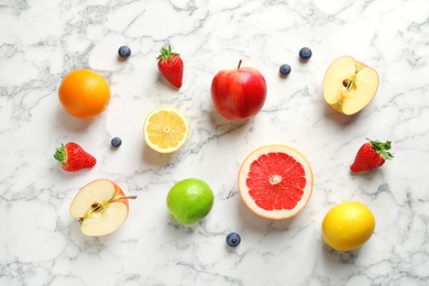 Flat lay composition with fresh fruits and berries on marble background
