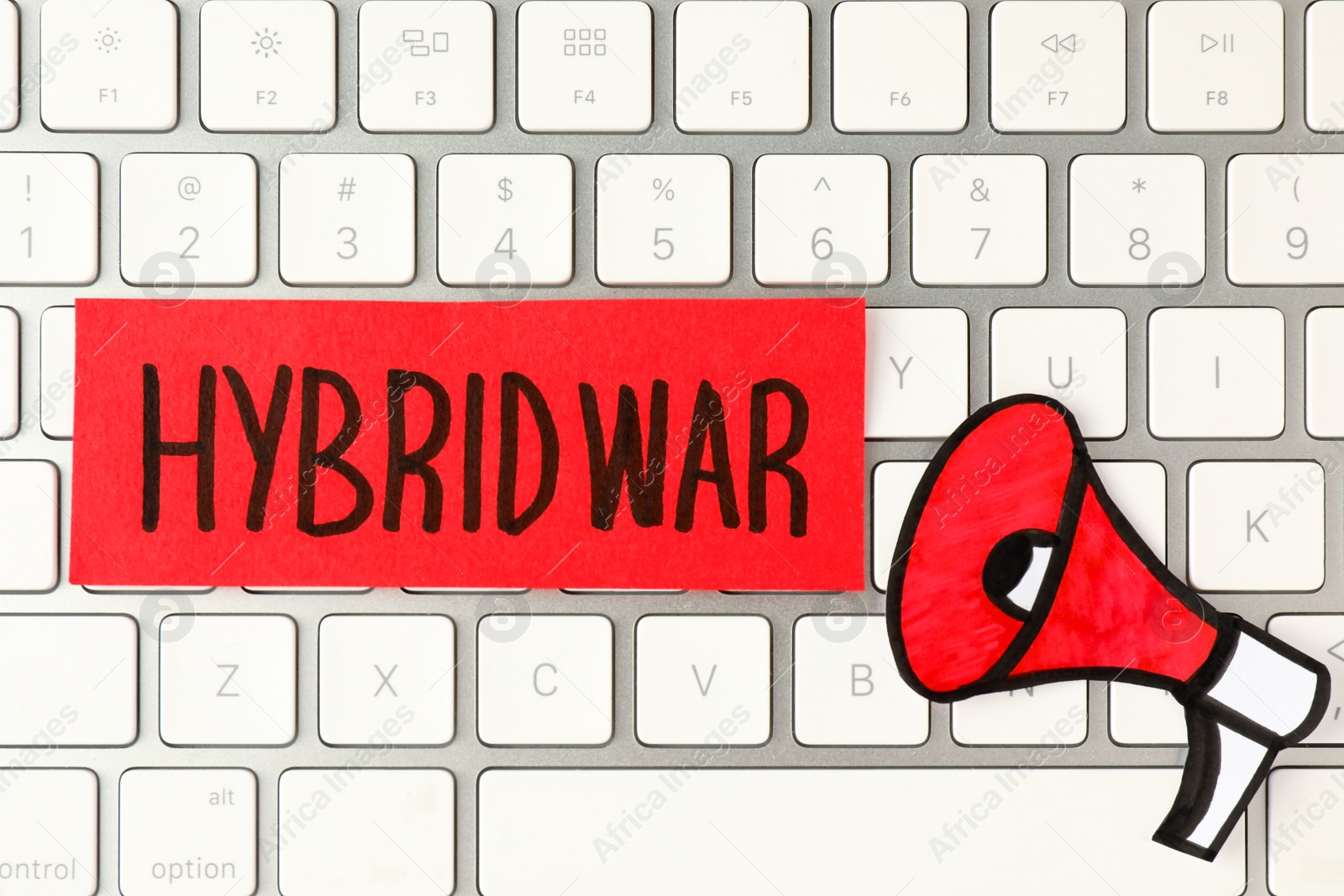 Photo of Card with words Hybrid War and paper megaphone on computer keyboard, top view