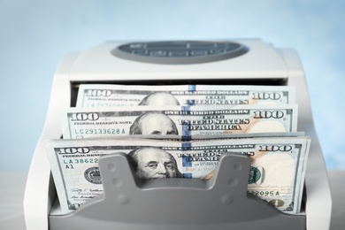 Photo of Modern bill counter with money, closeup view