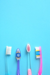 Photo of Flat lay composition with manual toothbrushes on color background