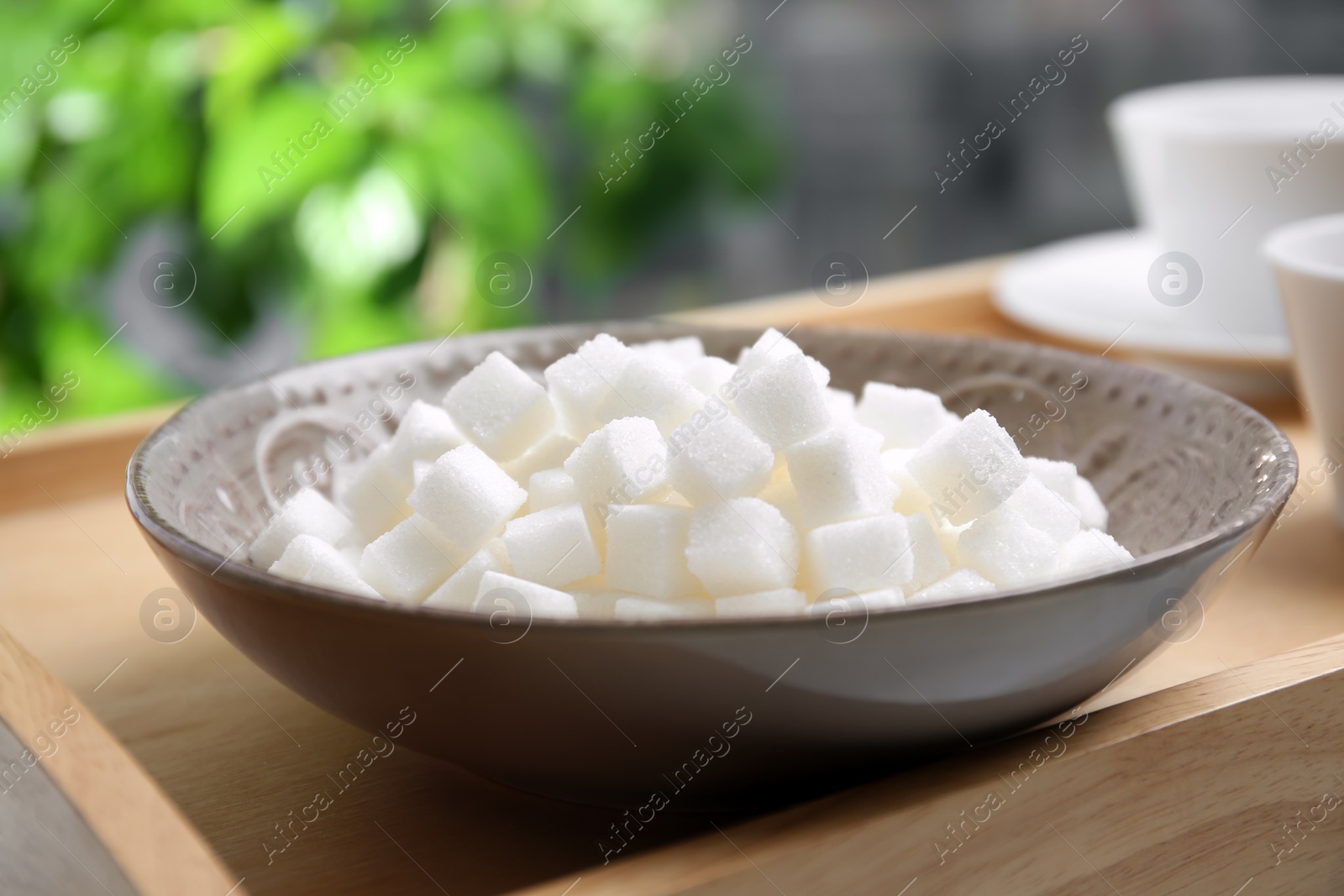 Photo of Bowl with refined sugar on table