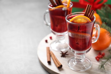 Photo of Glass cups with mulled wine on table. Space for text