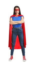Photo of Confident young woman wearing superhero cape and mask on white background