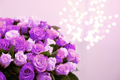 Image of Bouquet of violet roses against blurred background, closeup. Funeral attributes