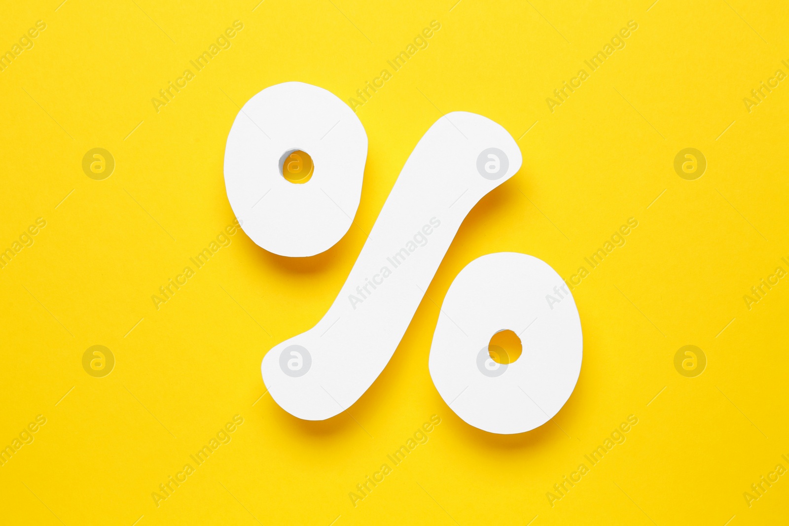 Photo of Percent sign on yellow background, flat lay