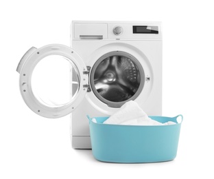 Modern washing machine and basket with laundry on white background