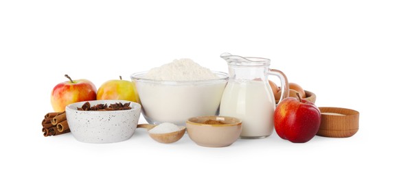 Photo of Jug with milk, flour and different ingredients on white background. Yeast pastry