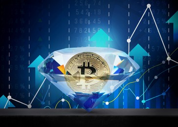 Golden bitcoin in shiny diamond against charts