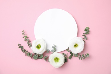 Photo of Fresh eucalyptus leaves, flowers and blank card with space for design on color background, top view