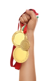 Photo of Woman holding gold medals on white background, closeup