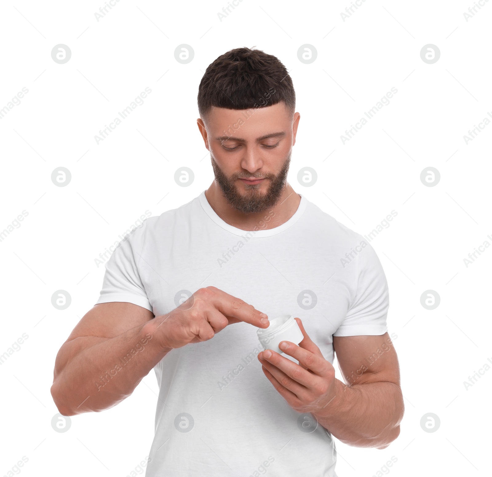 Photo of Handsome man applying body cream on white background