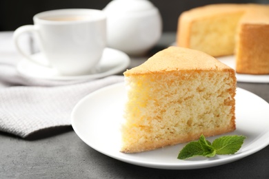 Piece of delicious fresh homemade cake on grey marble table