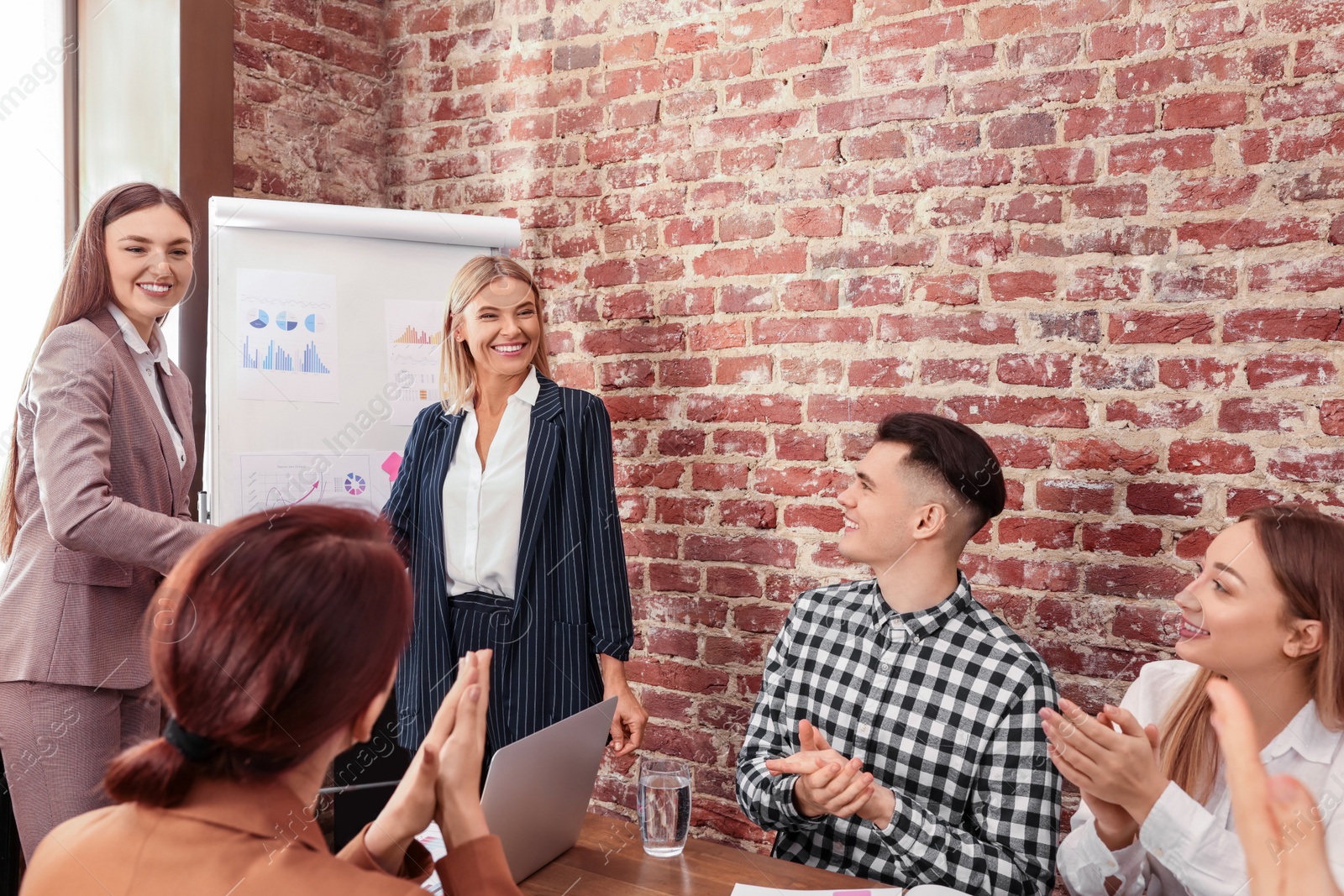 Photo of Businesswoman having meeting with her employees in office. Lady boss