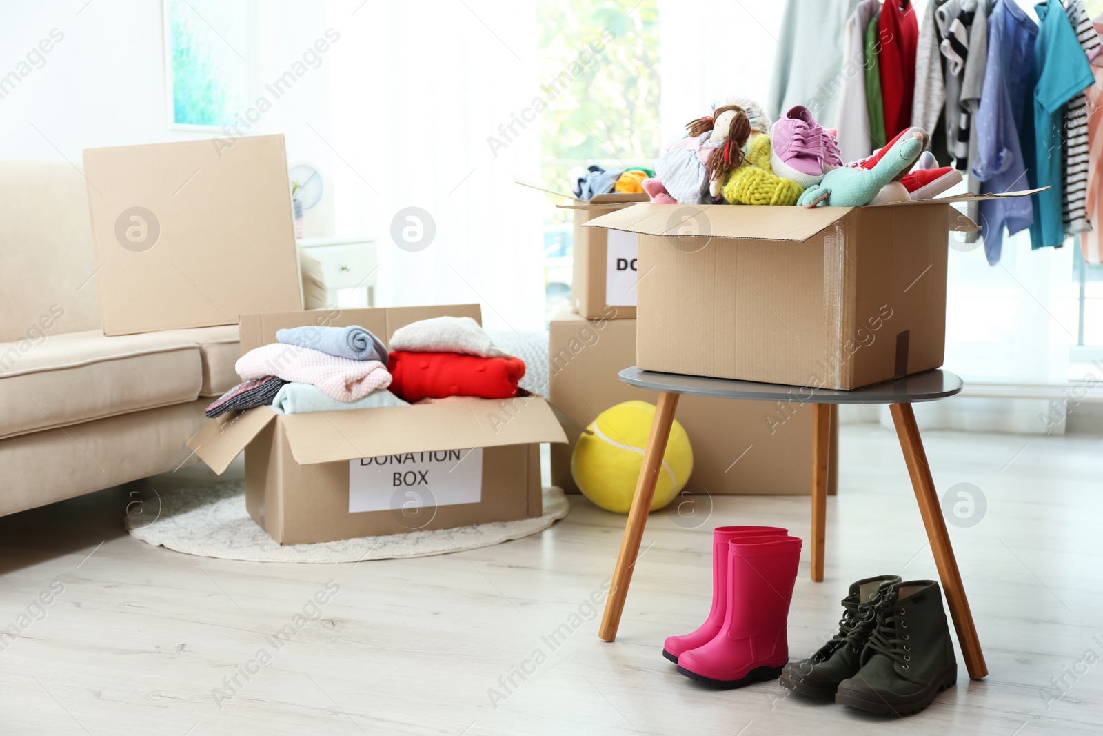 Photo of Carton boxes with donations in living room