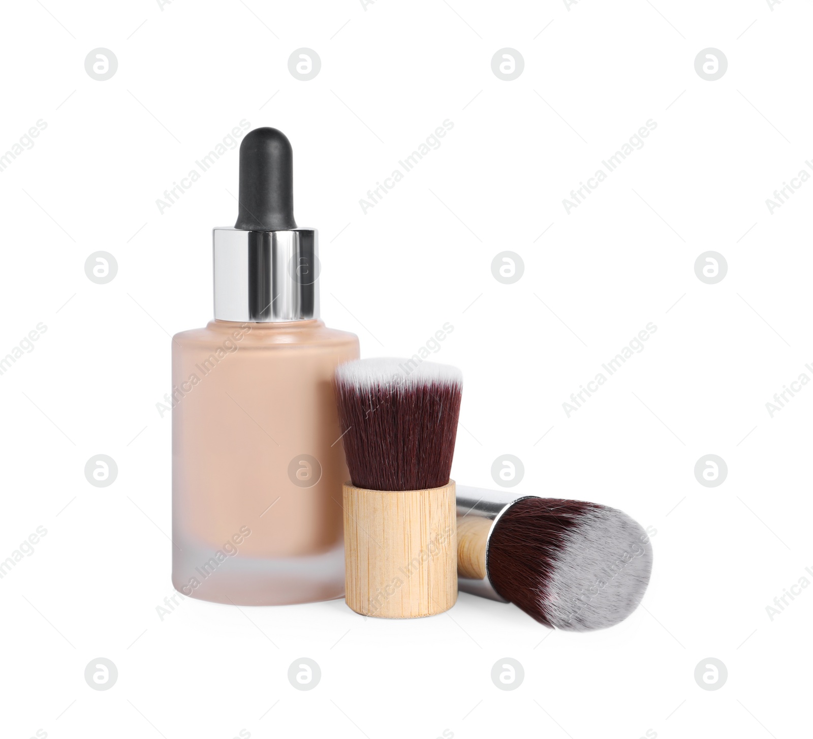 Photo of Bottle of skin foundation and brushes on white background. Makeup product