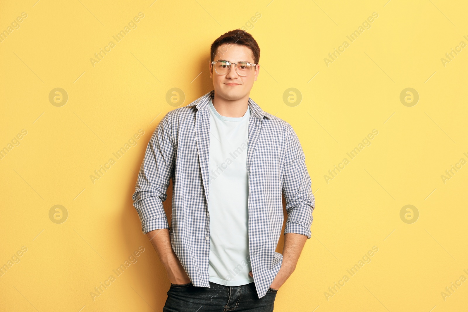 Photo of Portrait of confident young man on color background