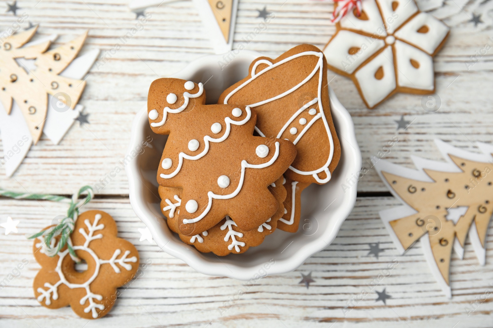 Photo of Bowl with tasty homemade Christmas cookies on table, top view