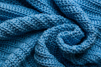 Beautiful light blue knitted fabric as background, closeup