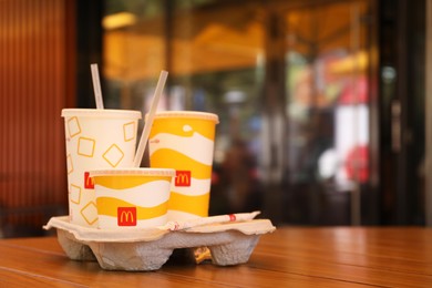 MYKOLAIV, UKRAINE - AUGUST 11, 2021: Cold McDonald's drinks on table in cafe. Space for text